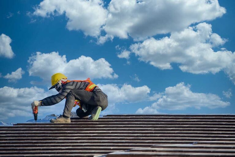 Homeowner checking roof shingles and gutters from the ground before leaving for vacation.